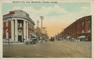 Colorized photograph of a city street with automobiles and a streetcar.