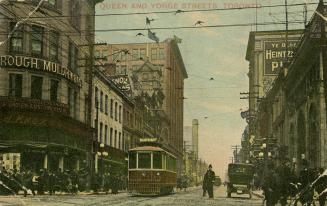 Colorized photograph of a very busy city street corner with automobiles and a streetcar. Police ...