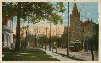 Colorized photograph of streetcars running along a wide city street. Houses on the left. and a  ...