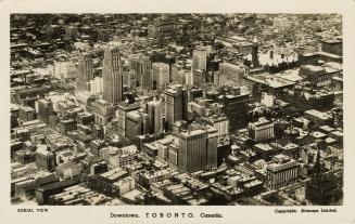Black and white aerial photograph of a large city with skyscrapers.