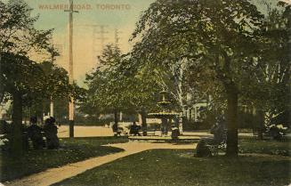Colorized photograph of people sitting near a fountain in a park. 