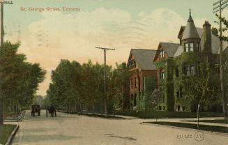 Colorized photograph of two horse drawn vehicles on a road with large, annex-style houses on ei ...