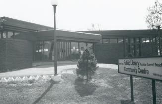 Picture of one storey library building and sign. 