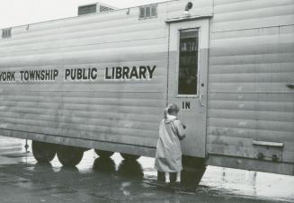 Picture of child lined up at a bookmobile. 