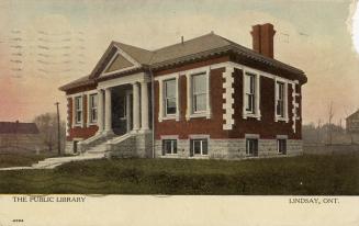 Picture of one story library building with four pillars and white border on bottom. 