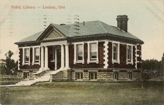 Picture of one story library building with four pillars. 