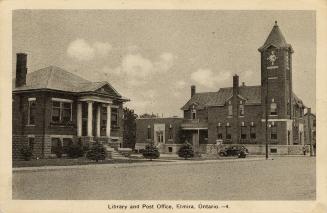 Picture of wide street showing public library building and post office building to the right. 