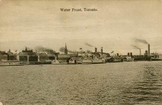 Black and white photograph of steamships on the water beside a large city.