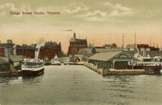 Colorized photograph of steam and other boats moored at busy, city docks.