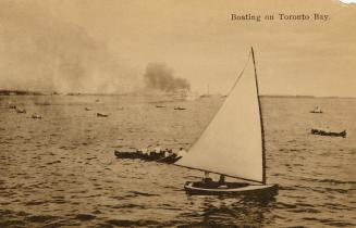 Black and white photograph of people in canoes and sailboats on choppy water.