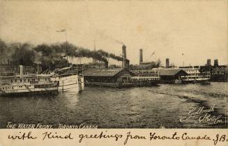 Black and white photograph of steamships moored in the water beside a large city.