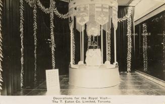 Black and white photograph of a crown decoration in a display in the interior of a department s ...