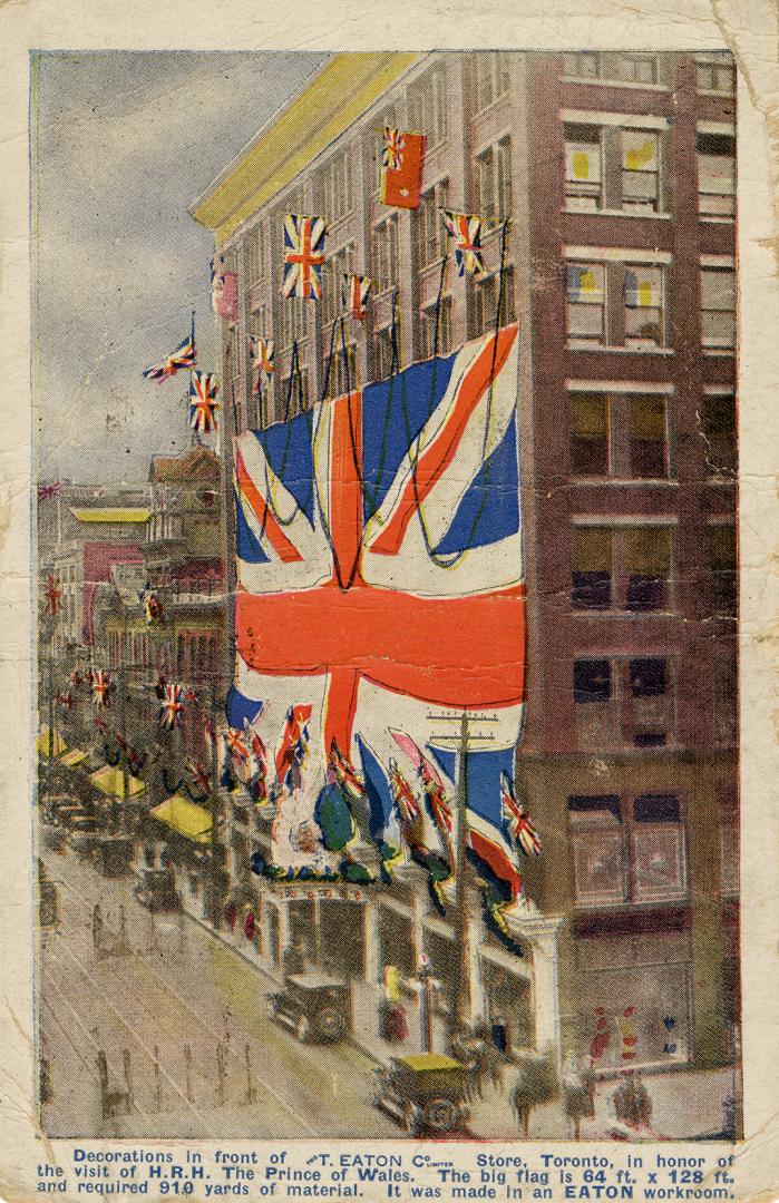 Colorized photograph of the exterior of a department store with a gigantic union jack hanging i ...