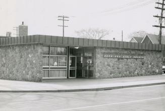 Picture of one storey library building with stone facing. 
