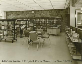Picture of interior of library branch showing children reading books. 