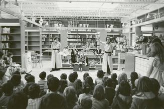 Picture of a puppet play and audience of children. 