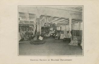Black and white photograph of an interior of a department store. Section is devoted to selling  ...