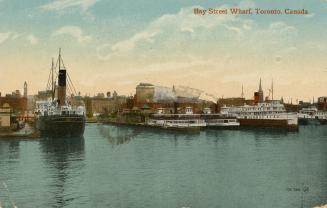 Colorized photograph of a steam boasts sailing in front of busy docks.
