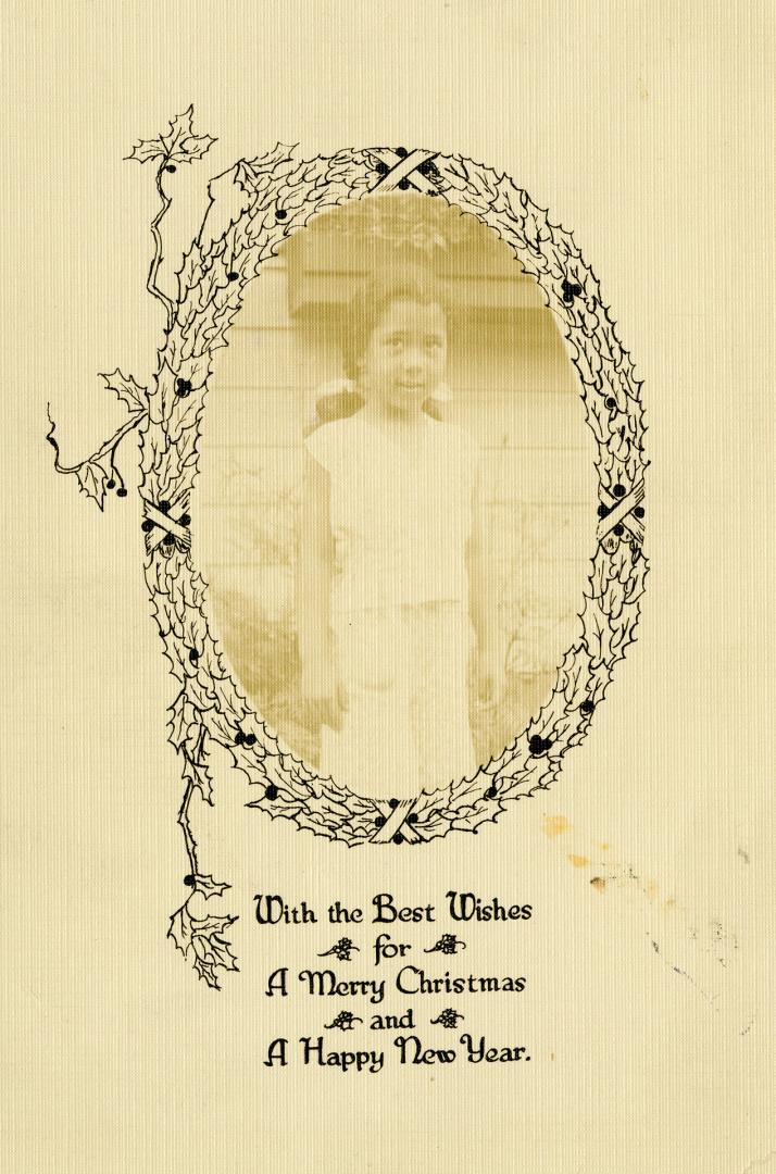Black and white Christmas card with unidentified child encircled by a wreath.
