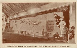 Sepia toned pictures of a military display inside an exhibition building.