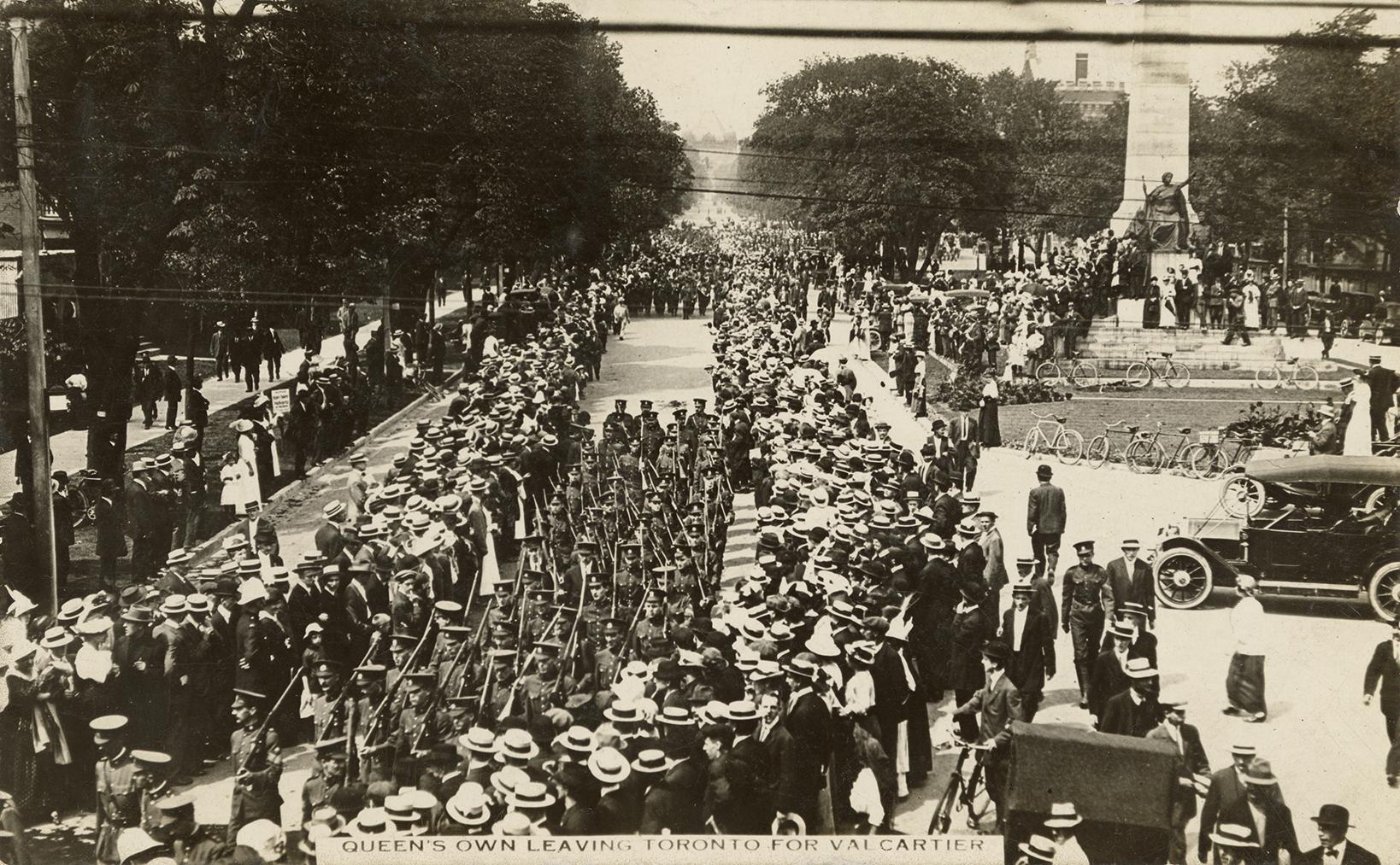 Black and white picture of soldiers marching down a wide street with the South African war memo ...