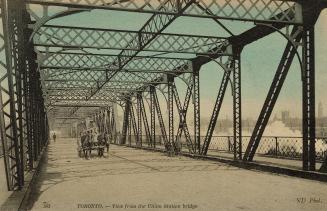 Colour photo postcard depicting the inside of the Union station bridge with a horse-drawn carri…