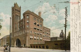 Colour postcard depicting a ground view of the exterior of Union station with two horse-drawn b ...