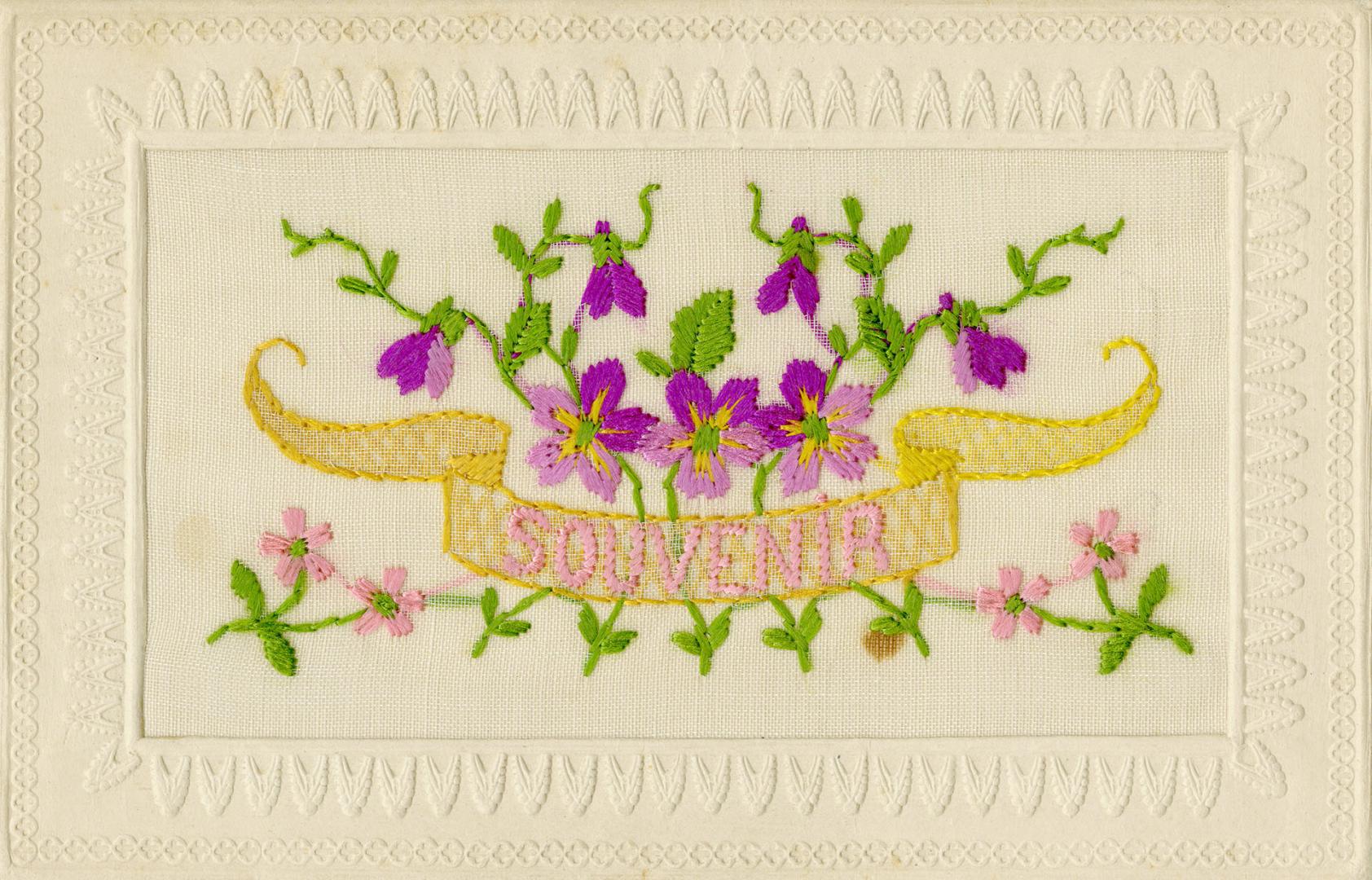 Silk embroidery of purple flowers behind a banner which reads "souvenir."