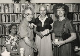 Picture of three women at library party. 