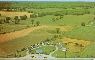Color picture taken from the air of vacation cabins in a semi circle. Farmland is in the backgr ...