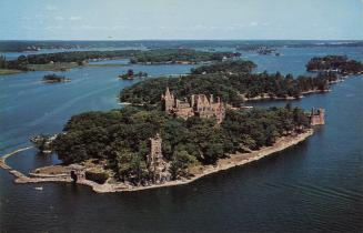 Color aerial photograph of a large, stone castle in an island in the middle of a waterway.