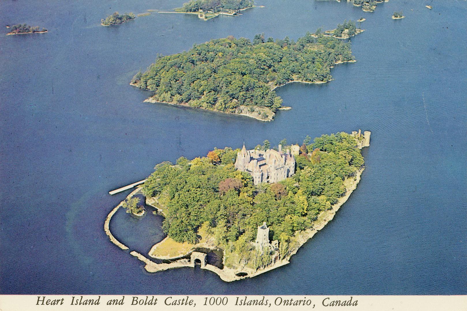 Color, aerial photograph of a view of a waterway, with a large castle on an island.
