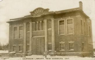 Picture of two storey library building with four pillars in front. 