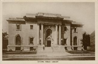Picture of large two storey public library building with pillars. 
