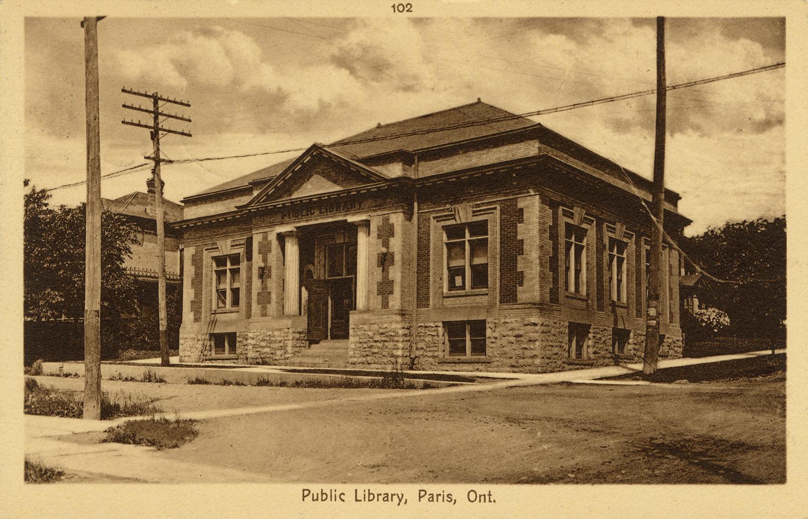 Picture of one storey library building with two front pillars. 