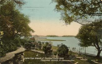 Colorized photograph of a large body of water with island in the background, taken from the ter ...