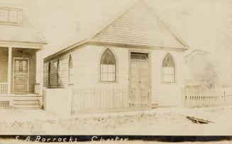 Sepia-toned postcard depicting the front of a residential building with the caption at the bott ...