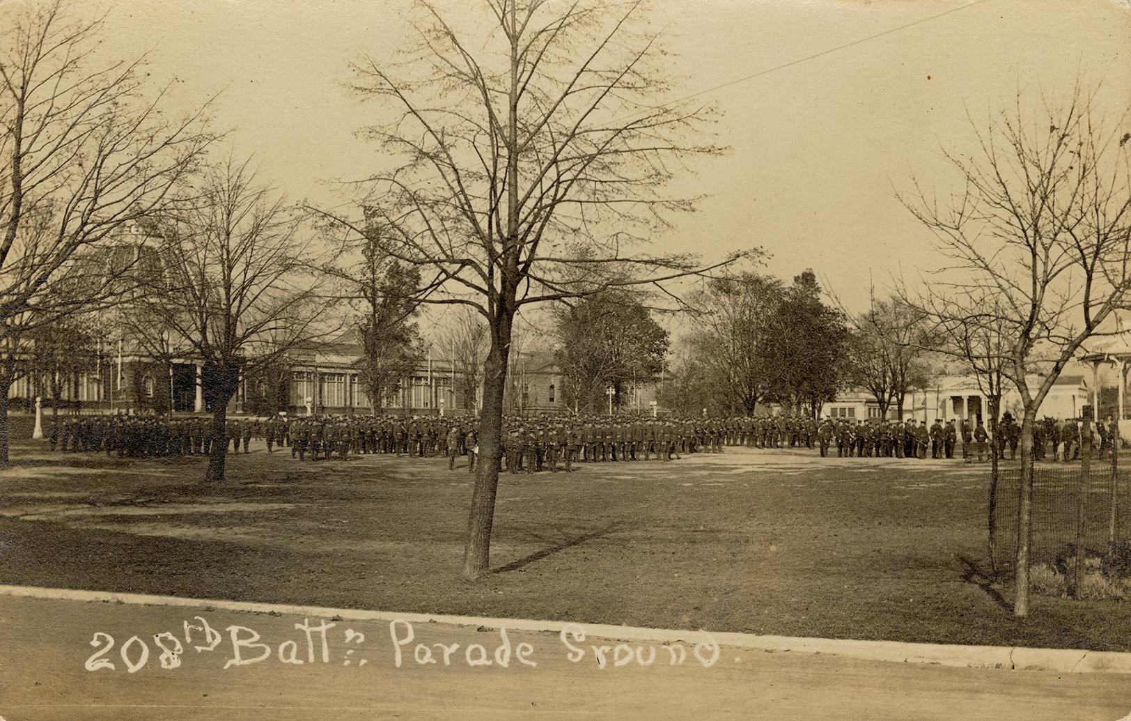 Black and white photograph of lines of servicemen in front of a very large building with a dome…