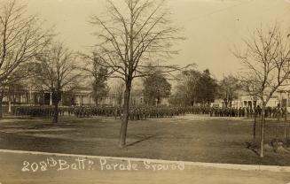 Black and white photograph of lines of servicemen in front of a very large building with a dome…