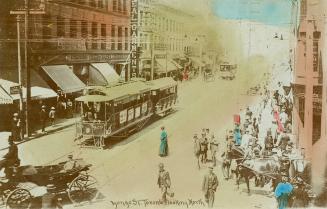 Colour photo postcard depicting a view of Yonge Street looking north from King Street with stre ...