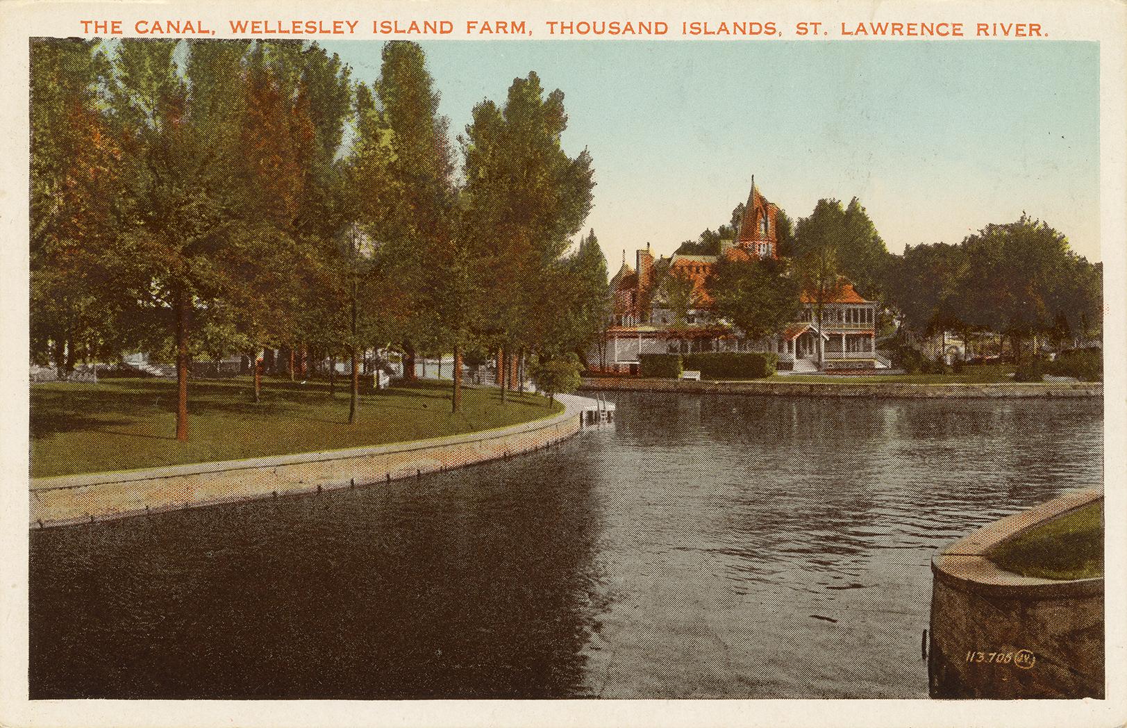 Colorized photograph of a large house built on a small island in the middle of a wide river.