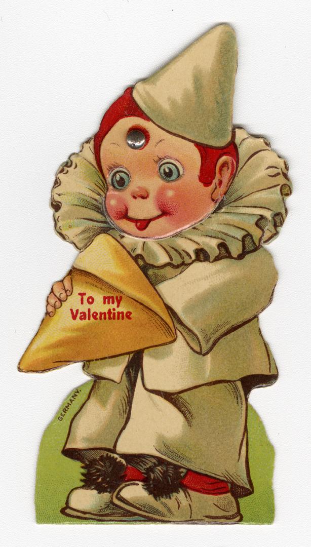 A mechanical card.A boy wearing a dunce hat and ruffle collar holds a triangle package that rea ...