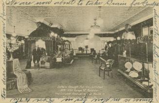 Black and white photo postcard depicting the interior of a fur store on Yonge Street. The capti ...