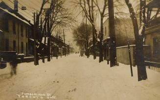 Black and white photograph of a city/residential street.