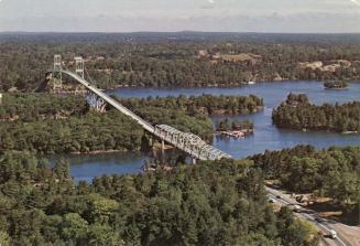 Color aerial photograph of a bridge spanning a river over many islands.