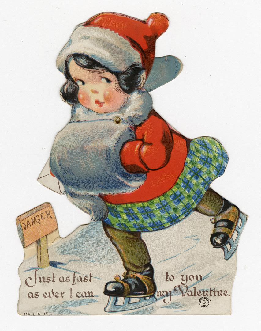 A mechanical card. A girl skates across ice holding a card with a heart on it in one hand. A ta ...