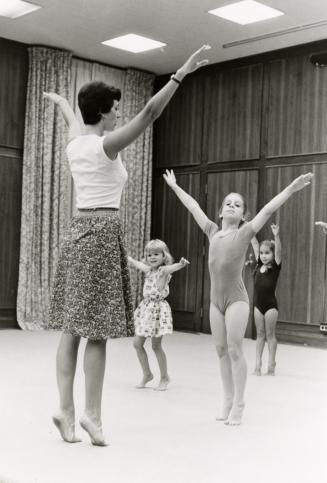 Picture of children and teacher at a ballet class. 