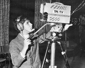 Picture of teenager using a television camera. 