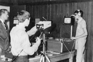 Picture of two teenagers using television equipment. 