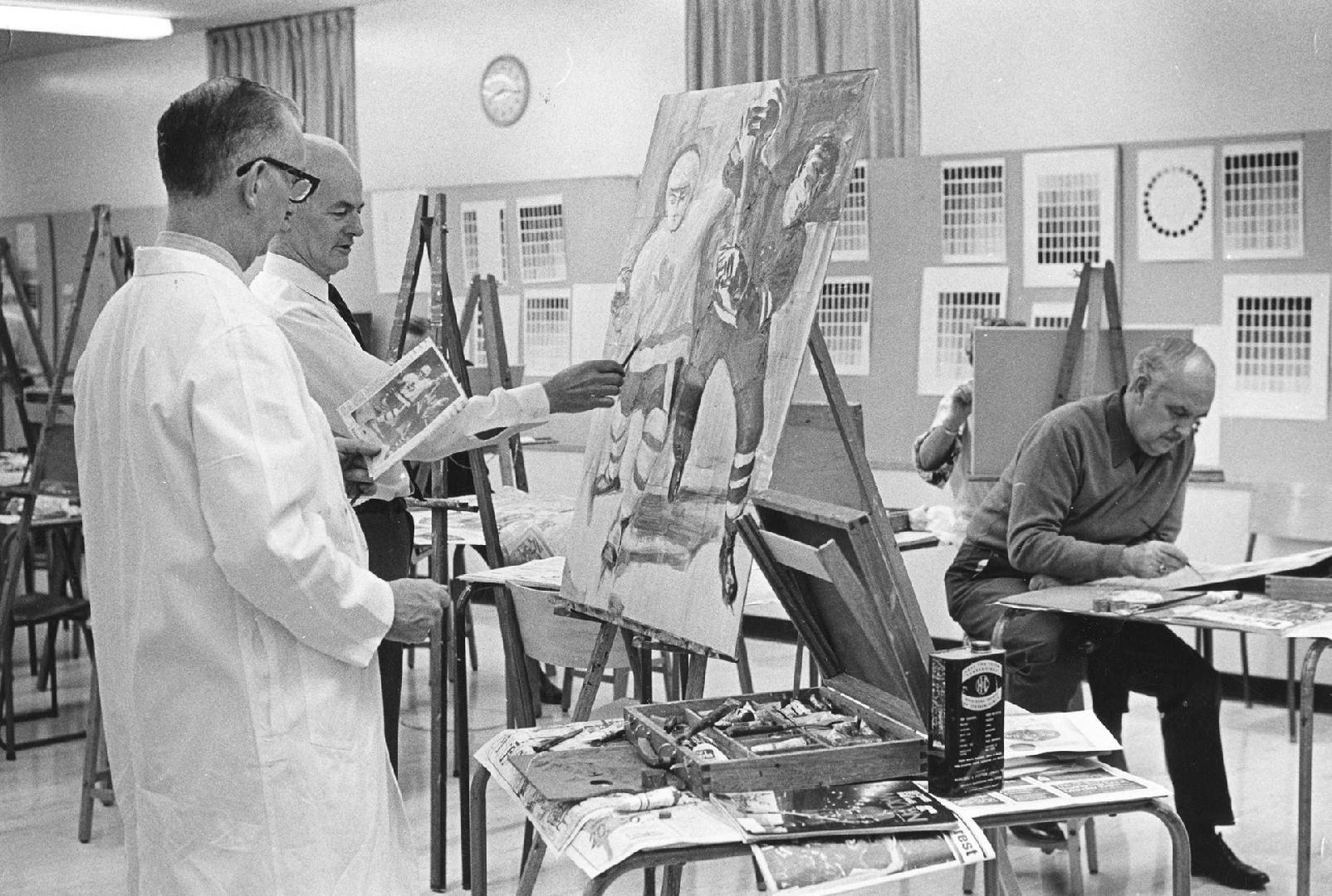 Picture of students in a painting class at easels. 